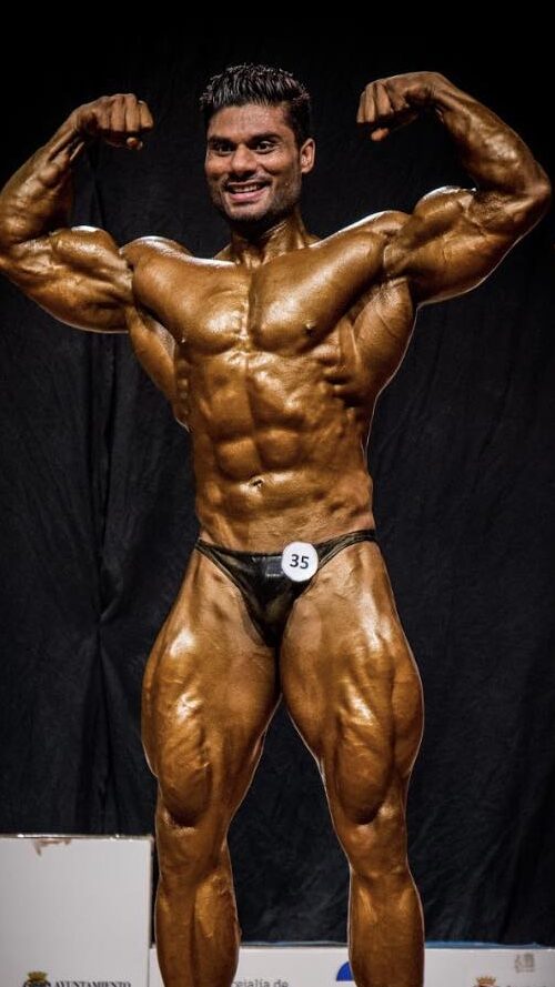 Indian Tiger Wasim Khan flexing muscles, Indian flag backdrop, World Champion medals